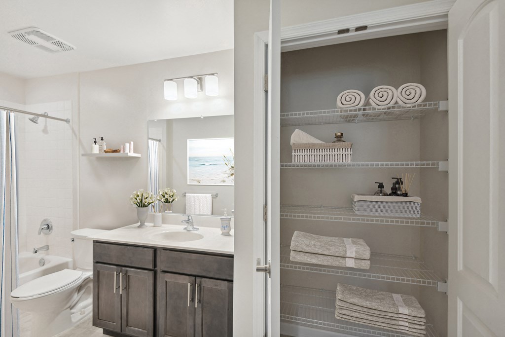 a bathroom with a shower and a sink and a mirror