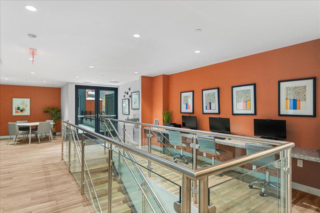 a conference room with a glass table and chairs and orange walls