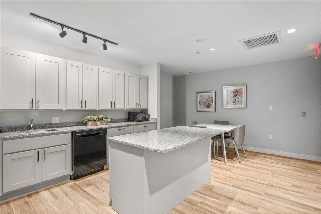 a kitchen with an island and a table with chairs