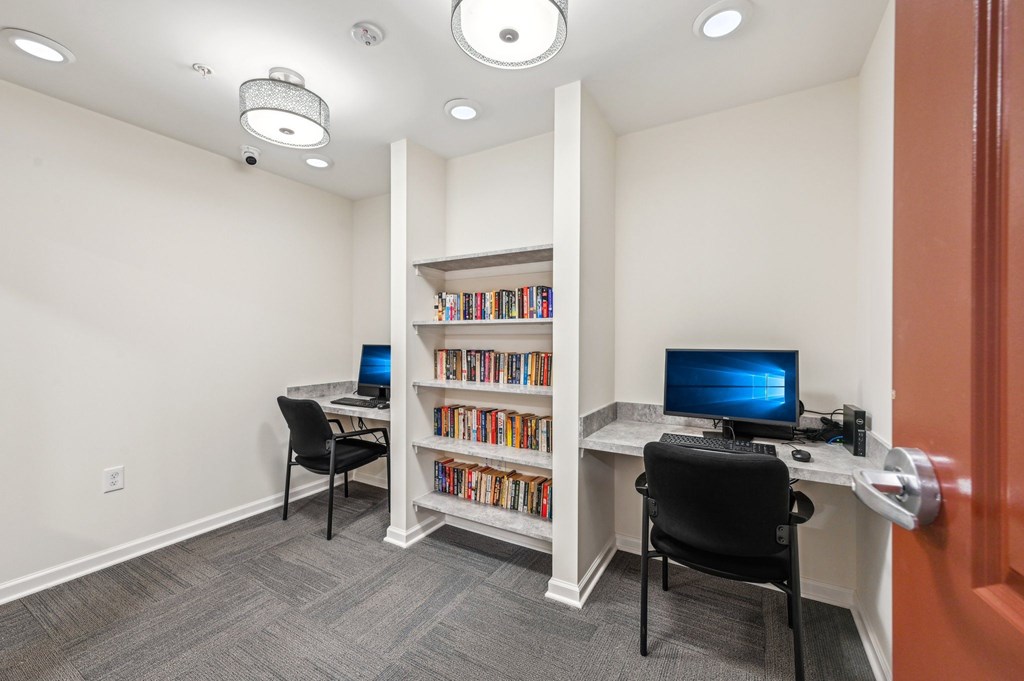A room with a desk, chair, and bookshelf.