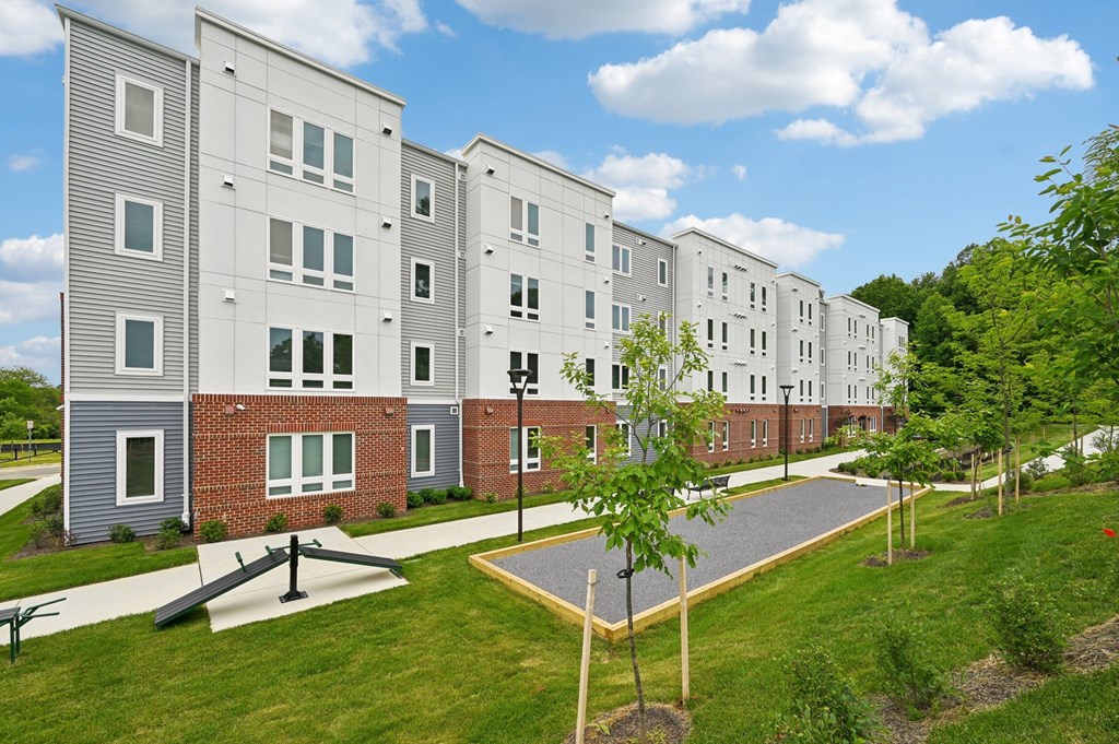 Apartment complex with a playground in front.