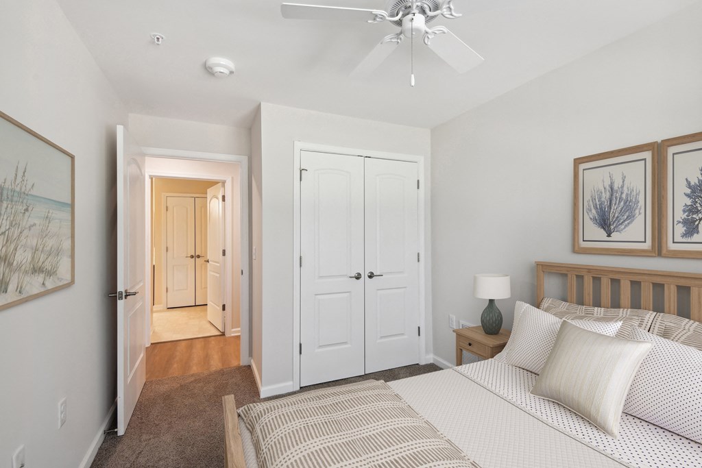 a bedroom with a bed and a ceiling fan