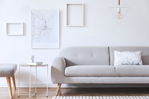 a living room with a gray couch and a table