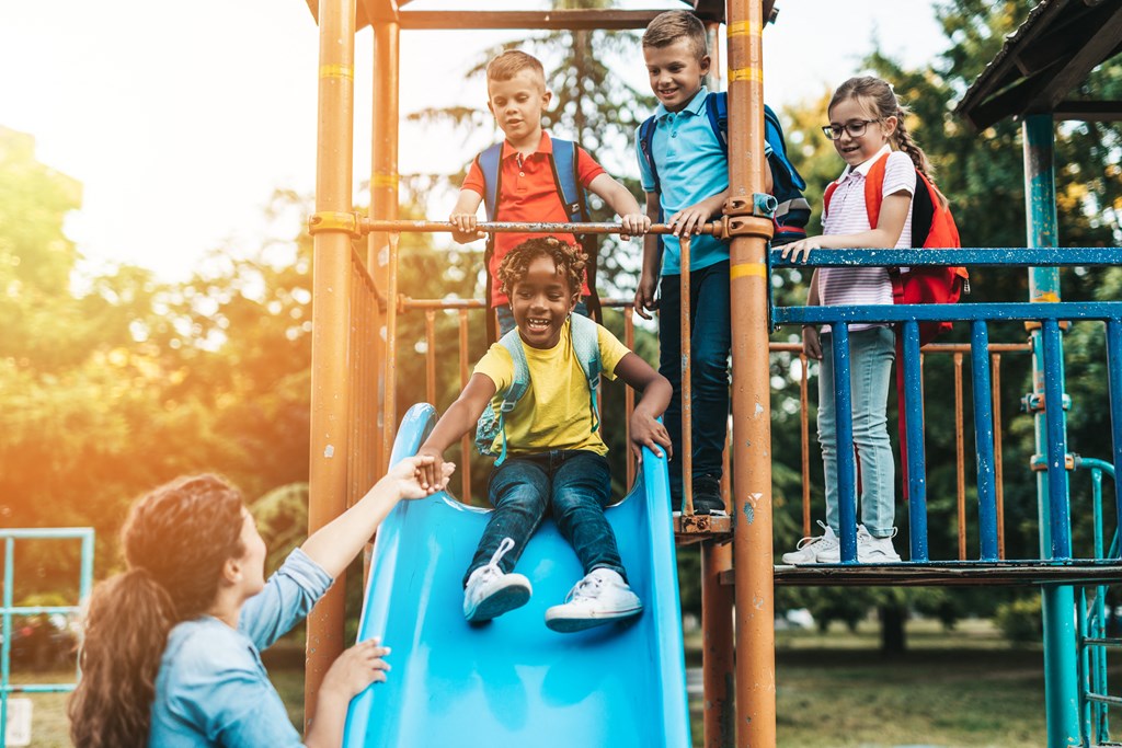 a group of children playing on a playground