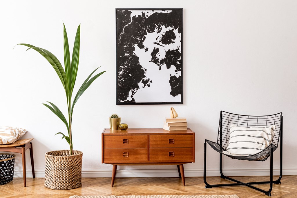 a black and white map of the world hanging on a wall in a living room