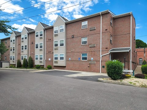 a large brick apartment building with a street in front of it