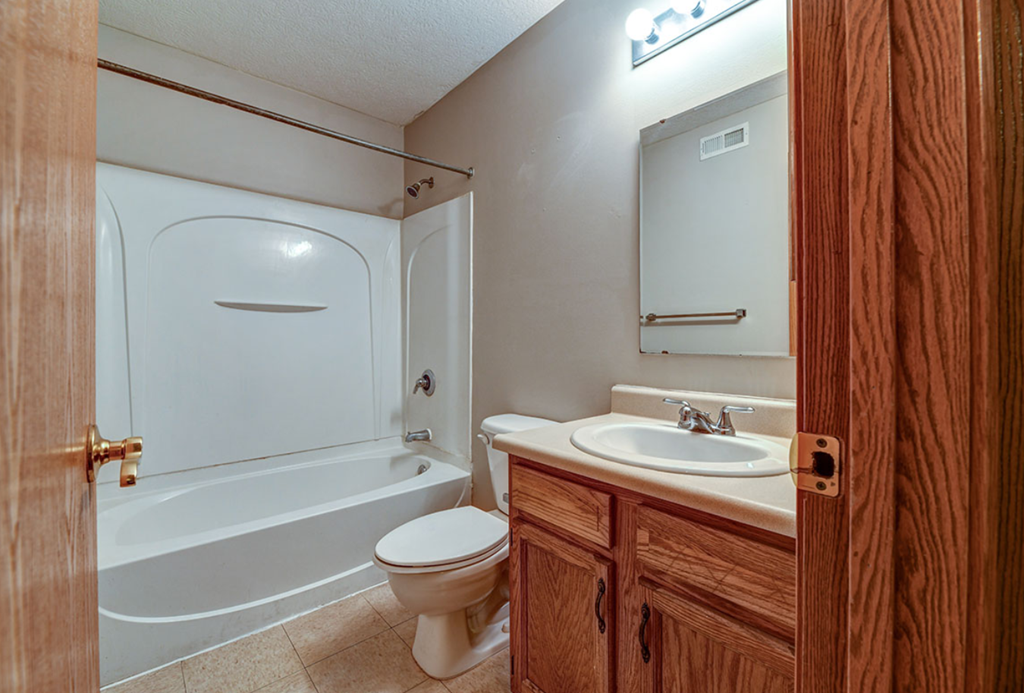 a bathroom with a sink toilet and a bath tub