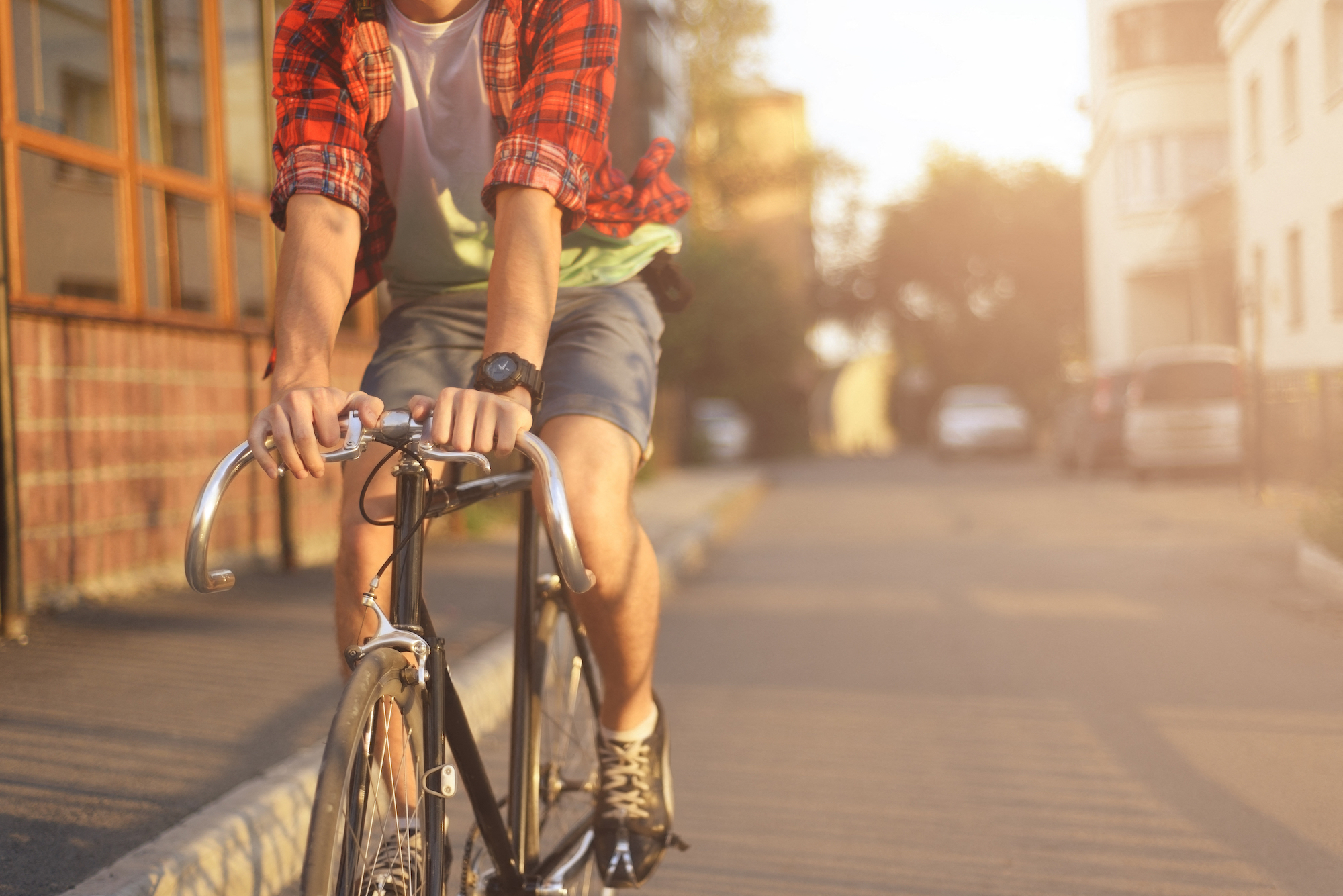 a man riding a bike down a city street