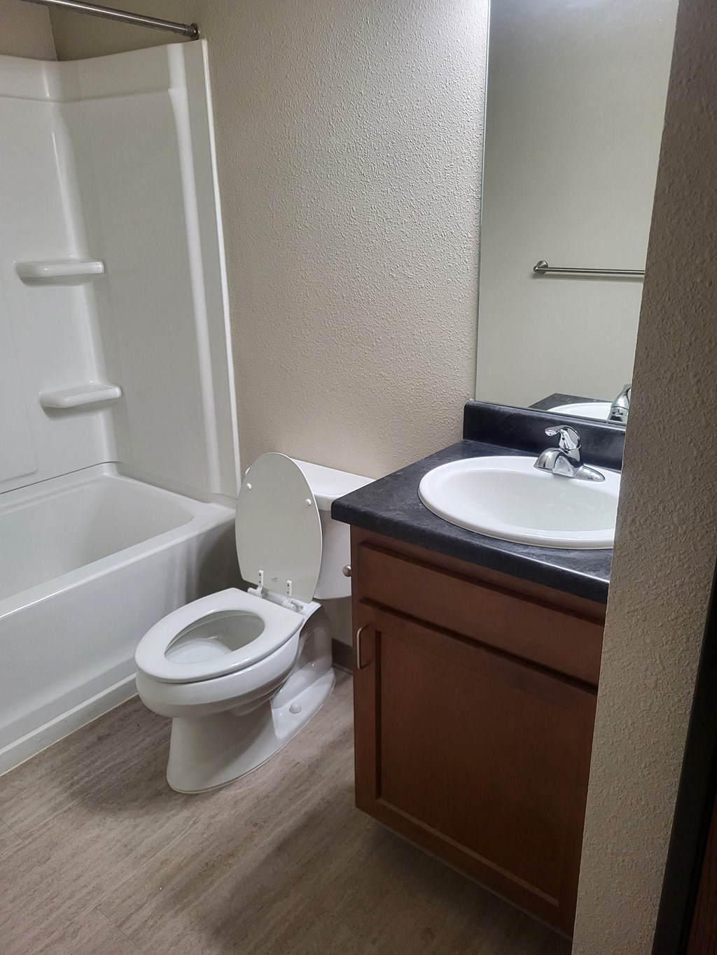an empty bathroom with a toilet and a sink