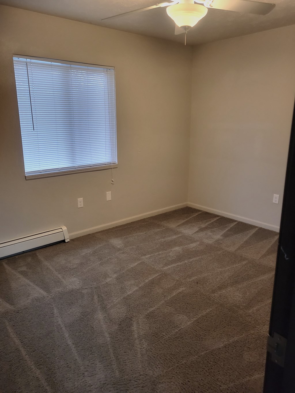 bedroom with carpet window and fan