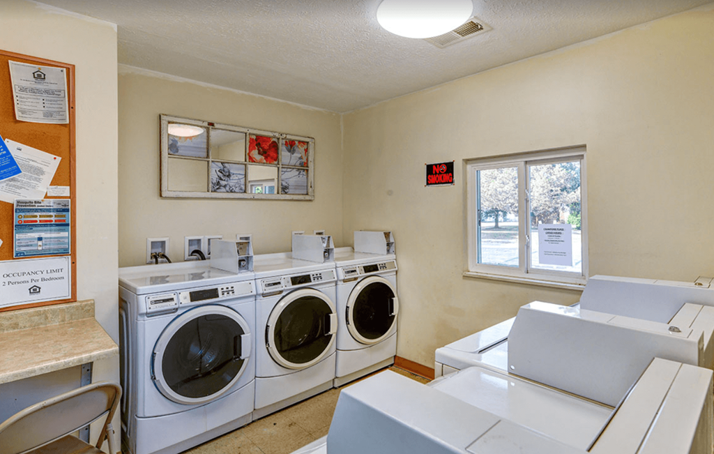 a laundry room with two washes and two dryers