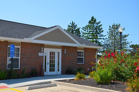 the front of a brick building with a white door