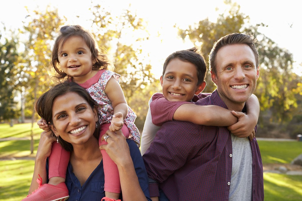 a family posing for a picture in a park