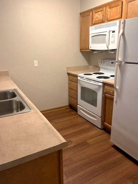 a kitchen with a stove and a refrigerator and a sink