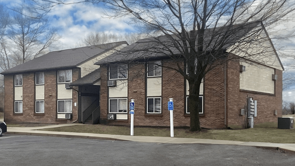 a brick house with a tree in front of it