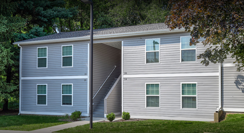 Apartment building with sidewalk and grass