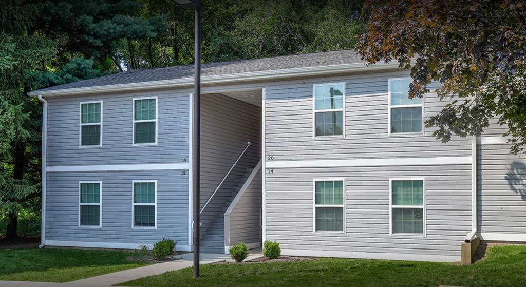 Apartment building with sidewalk and grass