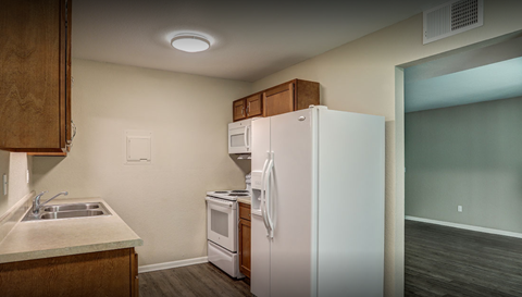 a kitchen with a refrigerator and a sink