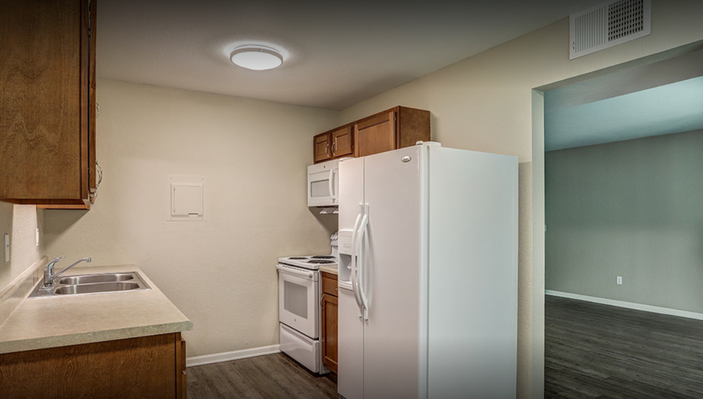 a kitchen with a refrigerator and a sink