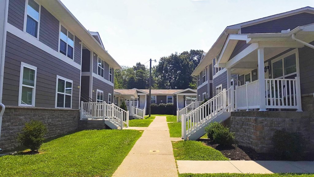 a row of houses with stairs and grass