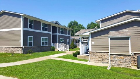 a row of houses in a neighborhood with green grass