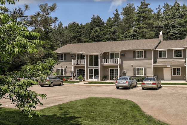a large house with cars parked in front of it