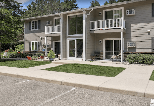 a house with a sidewalk and lawn in front of it