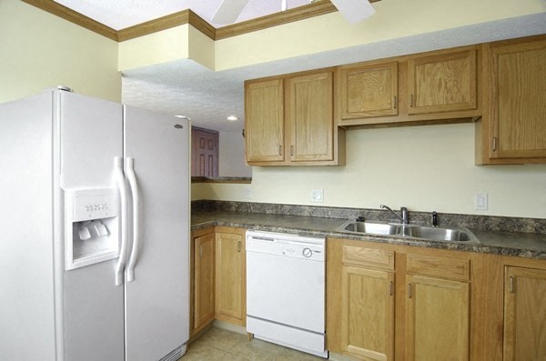 a kitchen with a white refrigerator and a sink