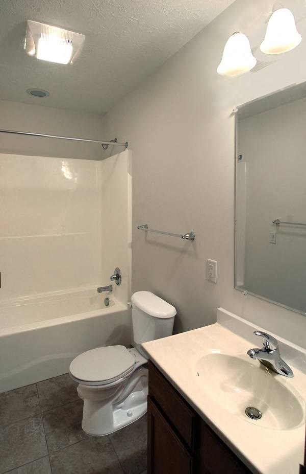 a bathroom with a toilet and a sink and a shower