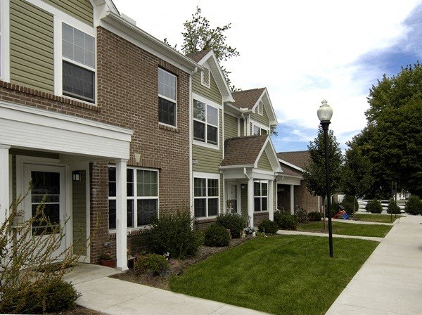 a row of houses with a sidewalk in front of them