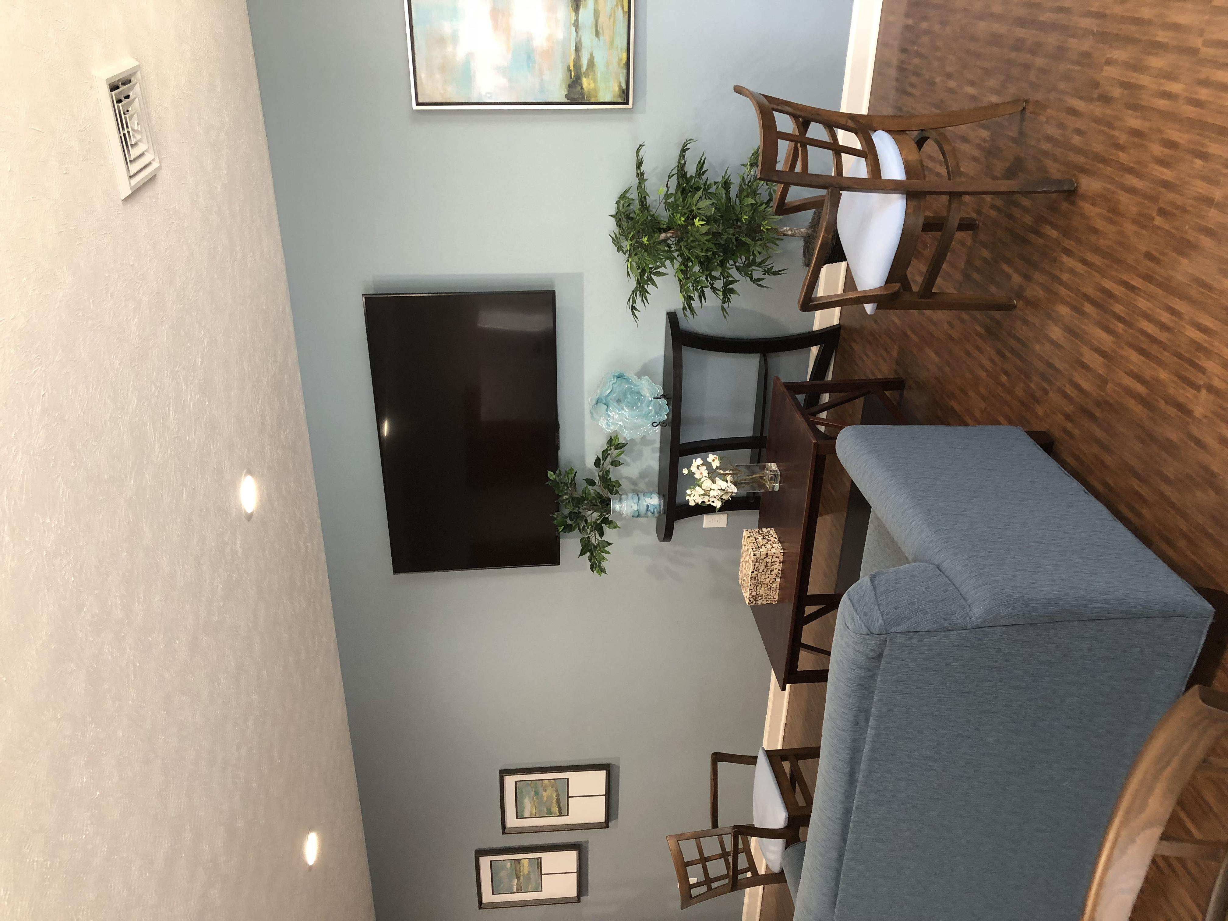 an overhead view of a living room with a tv and a dining room table