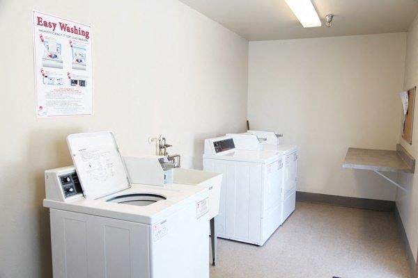 an empty laundry room with two washes and a washing machine