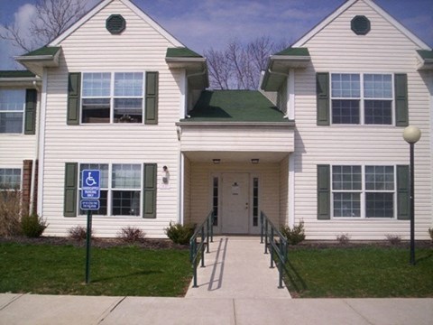 a white house with a sidewalk in front of it