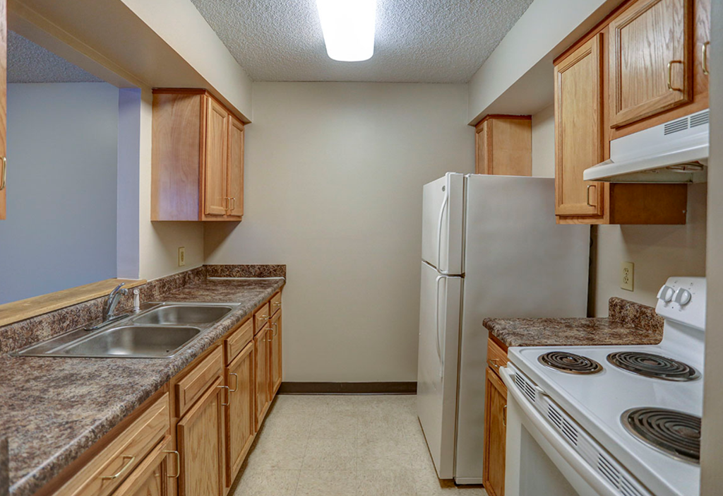 a kitchen with a stove sink and refrigerator