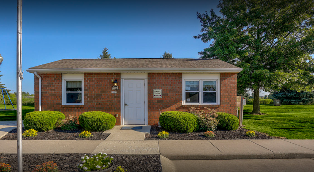 the front of a brick house with a white door