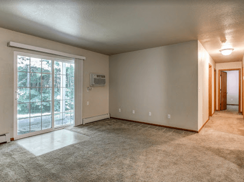 an empty living room with a sliding glass door