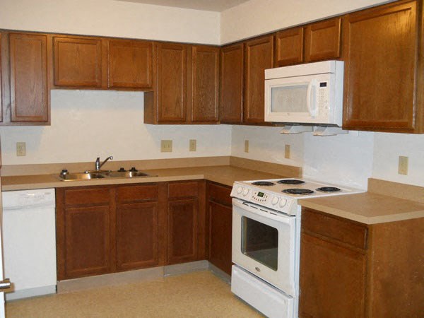 a kitchen with a stove microwave and sink