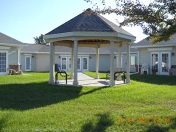 a gazebo in a yard in front of a house