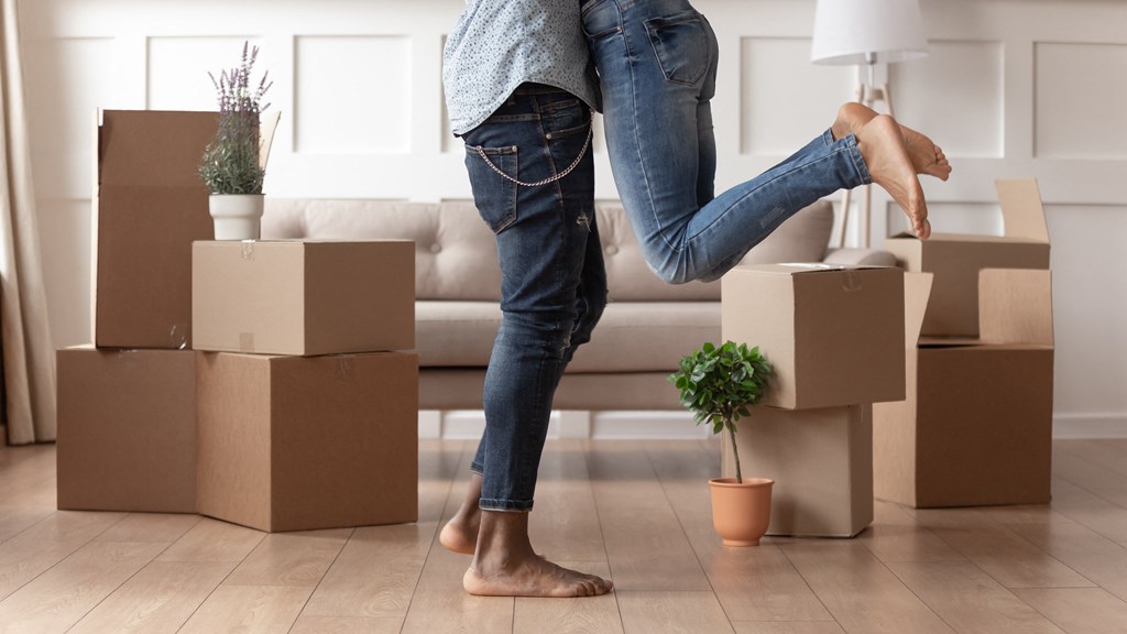 a woman with cardboard boxes in a living room