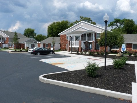 an empty parking lot in front of a house