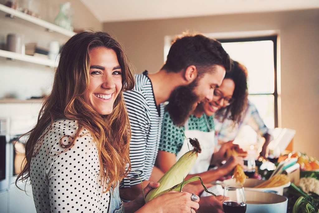 a group of people in a kitchen preparing food