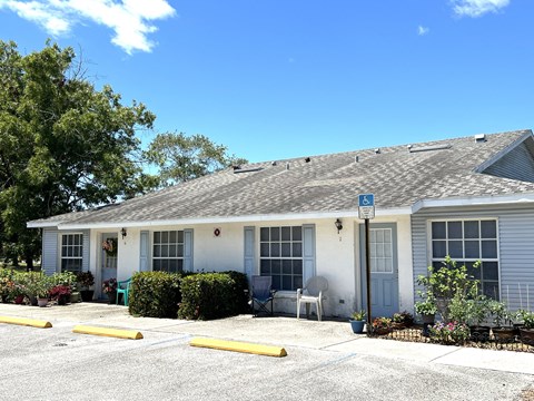 A small white building with a blue sign on the roof.