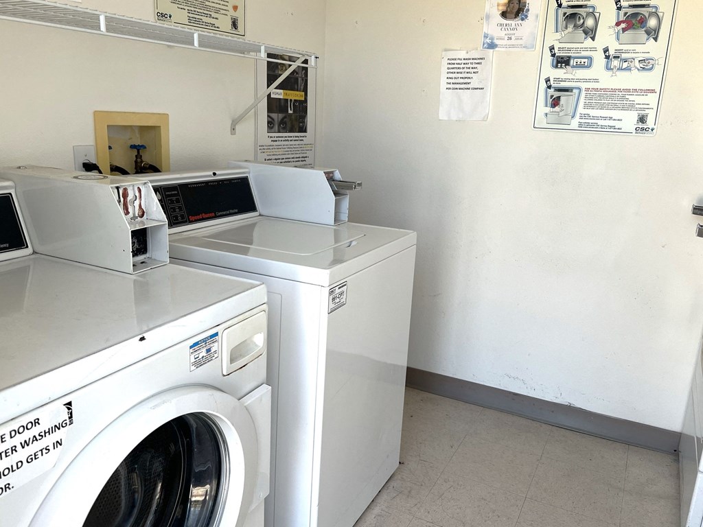 a washing machine and a microwave in a laundry room