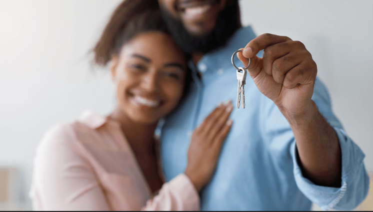 a man and woman holding a car key