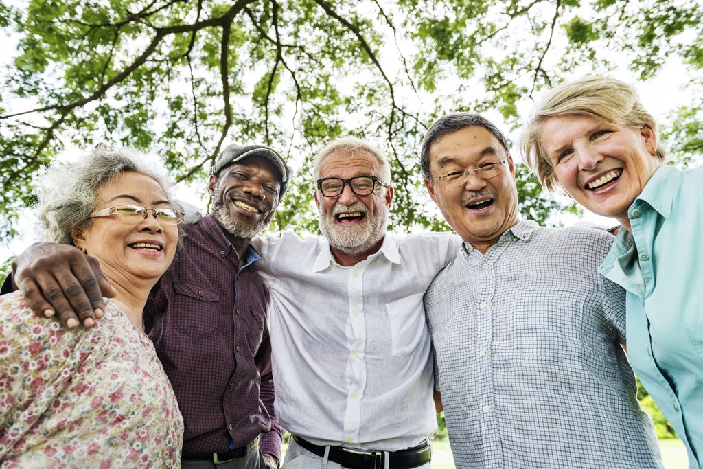 a group of people posing for a photo under a tree