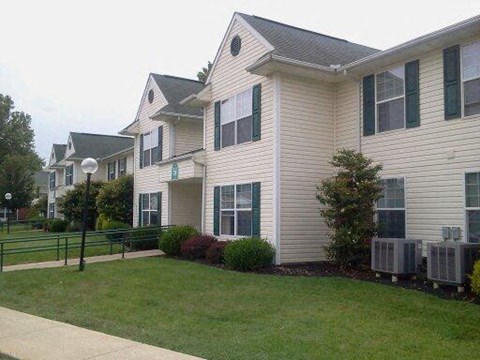 a white house with a lawn in front of it