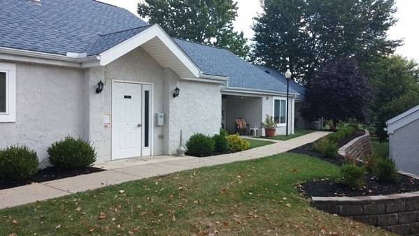 a white house with a sidewalk in front of it