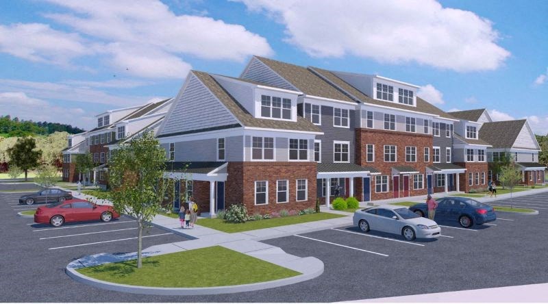 a rendering of an apartment building in a parking lot