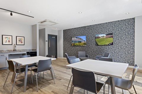 A modern dining room with a large table and chairs.