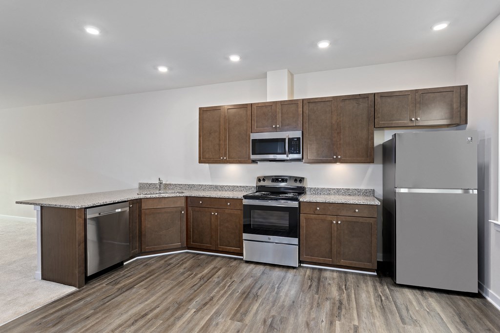 a kitchen with wooden cabinets and stainless steel appliances